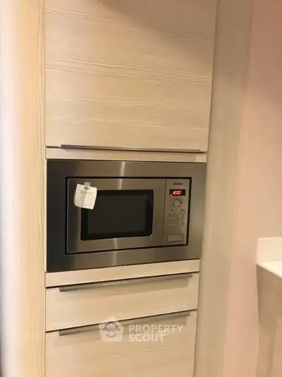 Modern kitchen with built-in microwave and sleek cabinetry