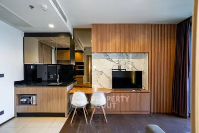 Modern living room with stylish wood paneling and integrated kitchen area