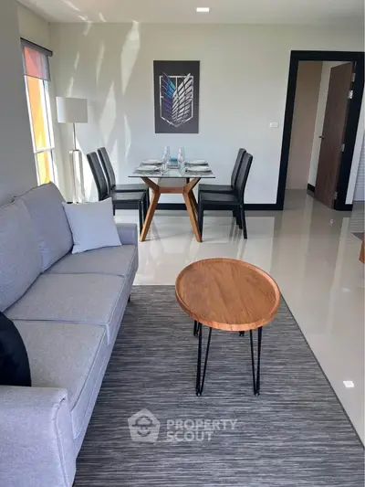 Modern living room with sleek furniture and dining area, perfect for contemporary living.