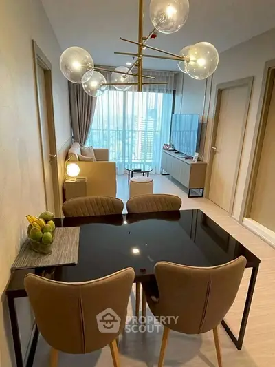 Modern living room with stylish dining area and large windows offering city views.