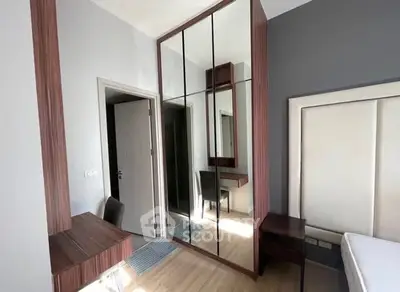 Modern bedroom with mirrored wardrobe and stylish decor