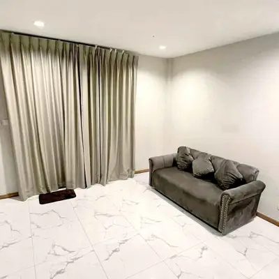 Cozy living room with elegant curtains and stylish sofa on marble floor