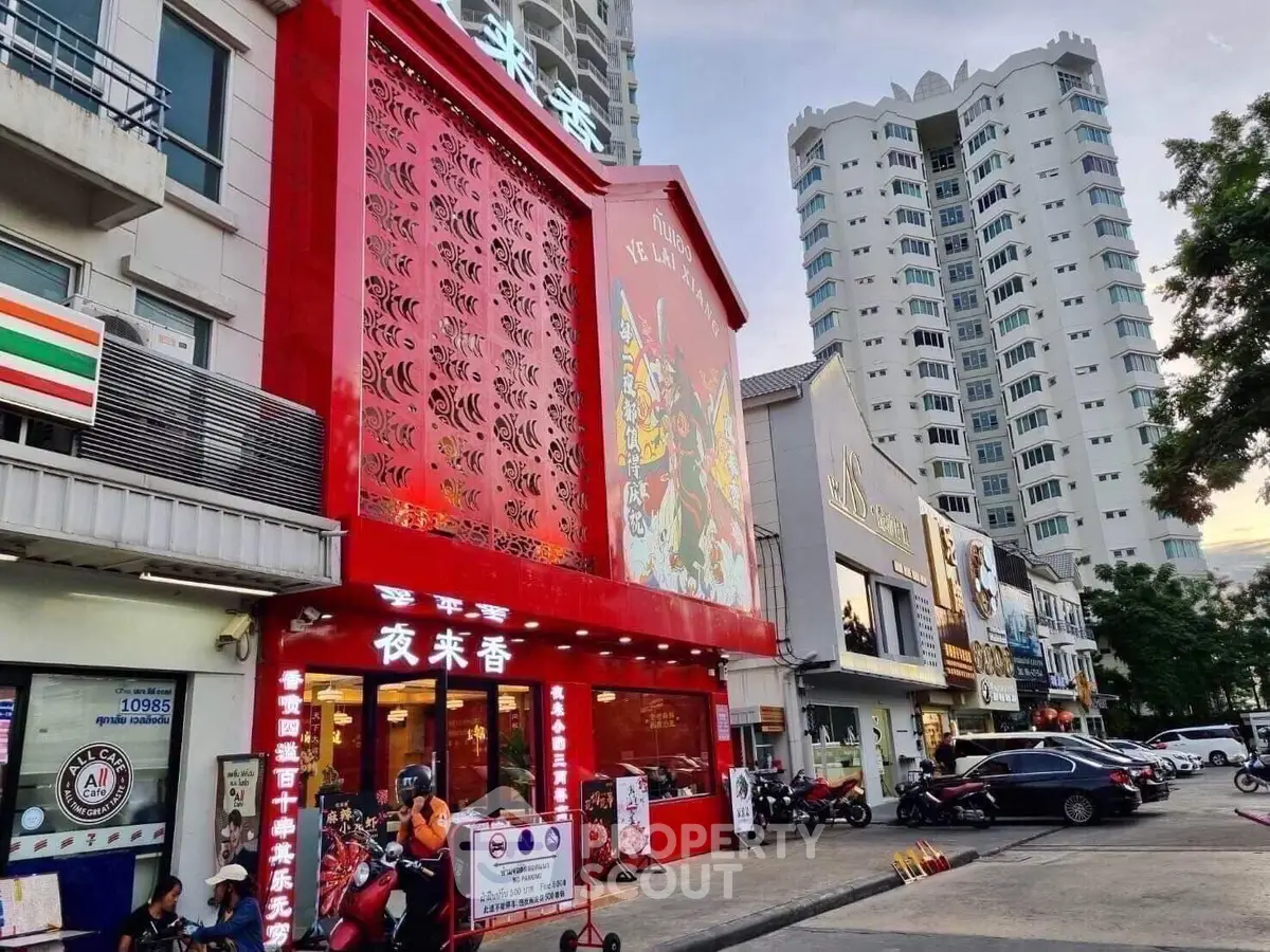 Vibrant street view with modern buildings and bustling activity, showcasing urban lifestyle.