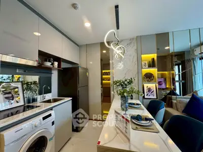 Modern kitchen with sleek appliances and stylish dining area in a contemporary apartment.