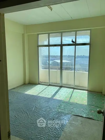 Spacious room with large windows offering a scenic view, perfect for customization.