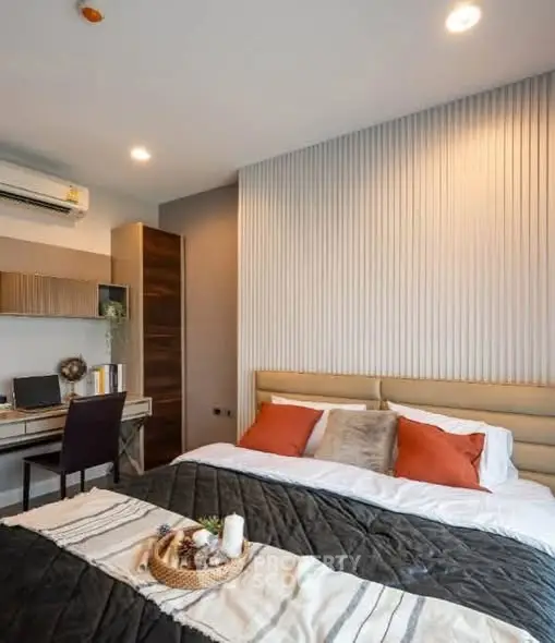 Modern bedroom with stylish decor and workspace, featuring cozy bedding and ambient lighting.