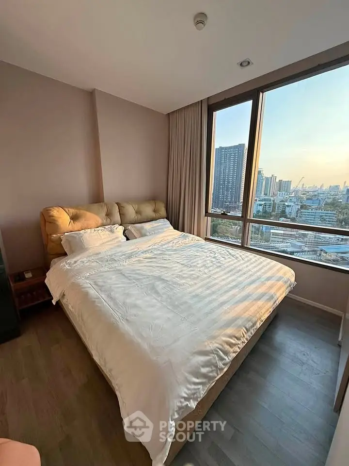 Spacious bedroom with city view in modern apartment