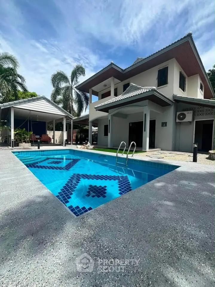 Stunning two-story home with a private pool and lush surroundings, perfect for luxurious living.