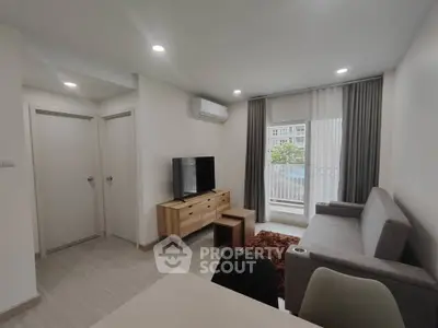 Modern living room with sleek furniture and natural light, perfect for urban living.