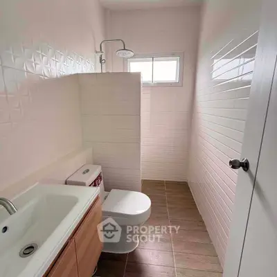 Modern bathroom with sleek white tiles and compact design
