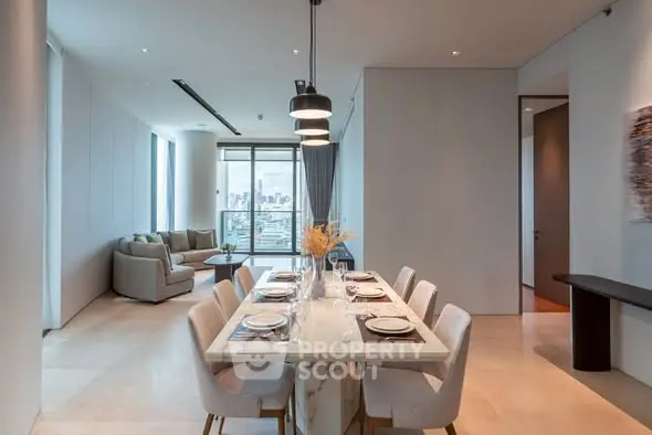 Luxurious open-plan dining and living area with city view and elegant decor.