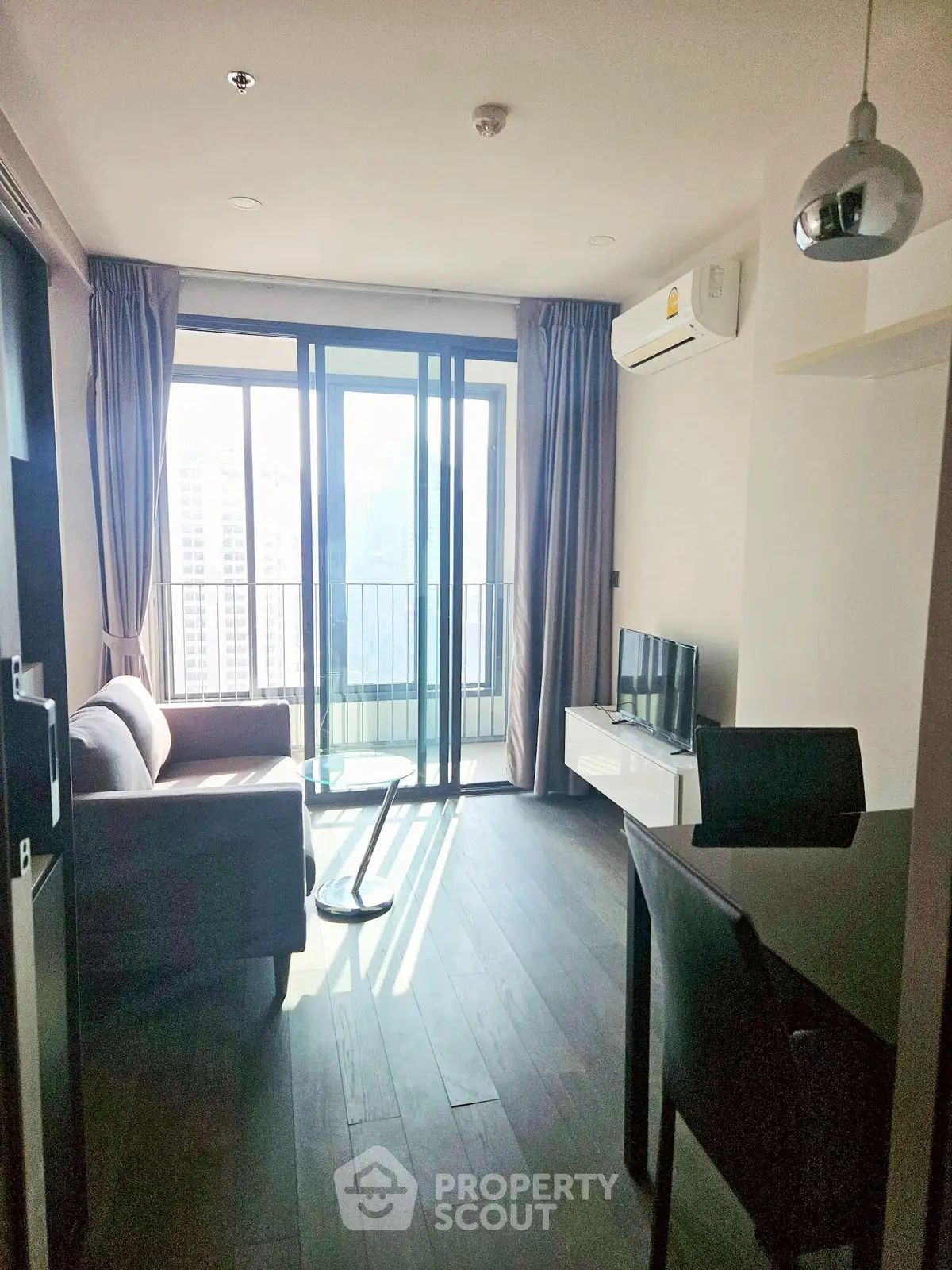 Modern living room with balcony view in high-rise apartment