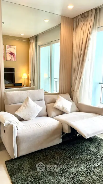 Cozy living room with plush sofa and elegant decor, perfect for relaxation.