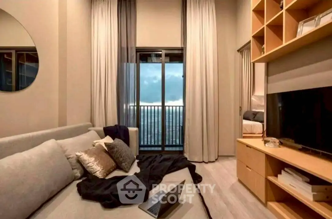 Modern living room with cozy sofa, large window view, and stylish decor