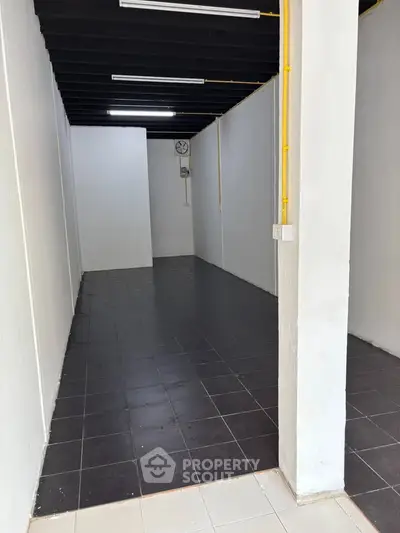 Spacious interior with tiled flooring and high ceiling, ideal for versatile real estate opportunities.