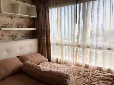 Cozy bedroom with city view, featuring elegant curtains and stylish wallpaper.