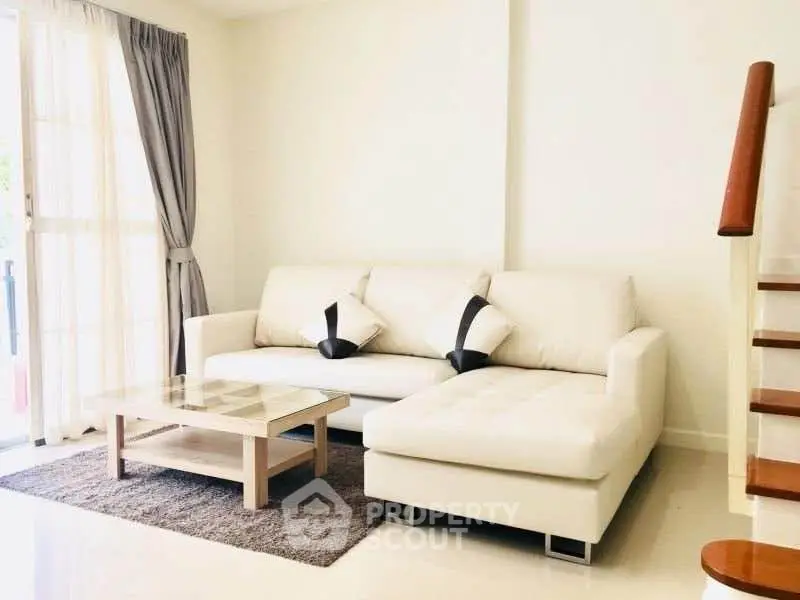 Bright and modern living room with white sofa and natural light