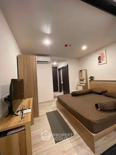 Modern bedroom with wooden furniture and stylish decor in a cozy apartment.