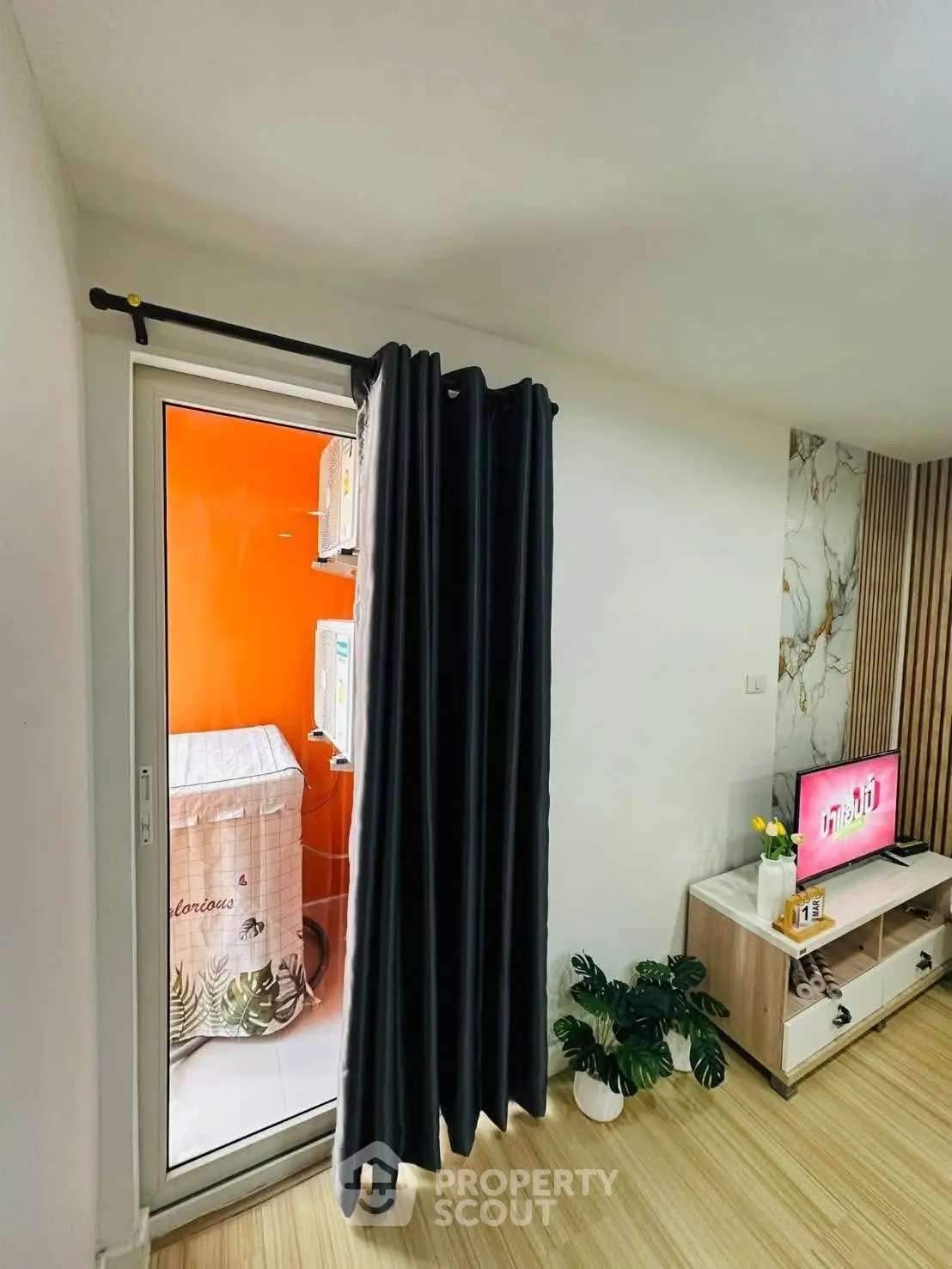 Modern living room with stylish decor and balcony access