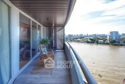 Spacious balcony with stunning river view in modern high-rise apartment.