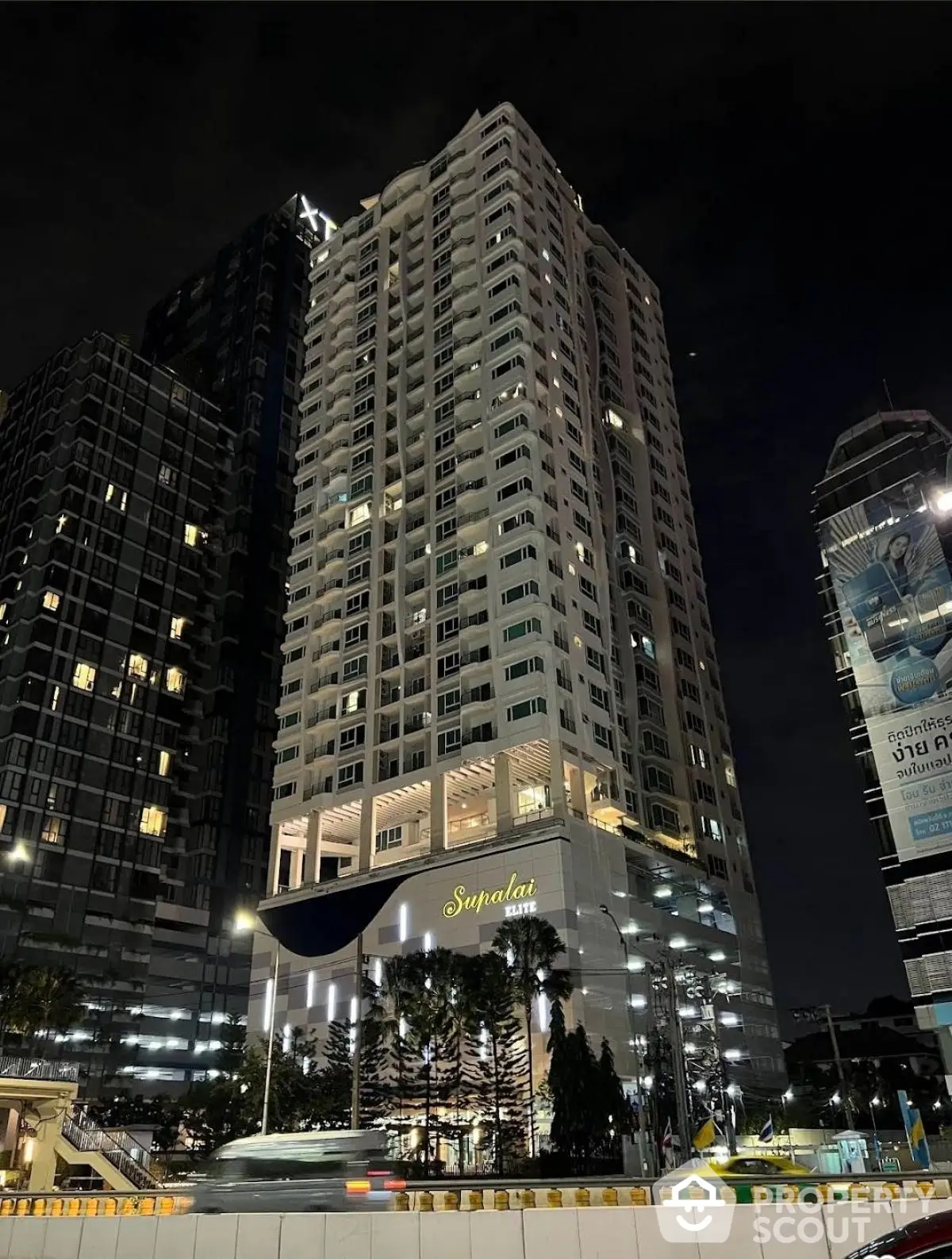 Stunning night view of a modern high-rise residential building in the city center.