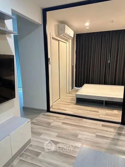 Modern apartment interior with sleek flooring and air-conditioned bedroom