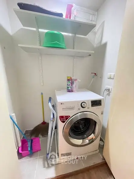 Compact laundry area with modern washing machine and storage shelves in a cozy home setting.