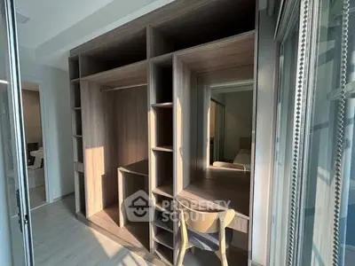 Modern study area with built-in wooden desk and shelves, perfect for home office setup.