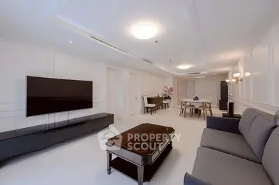 Spacious modern living room with sleek furniture and large TV