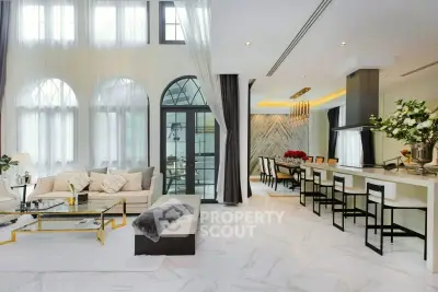 Luxurious open-plan living and dining area with high ceilings and elegant decor