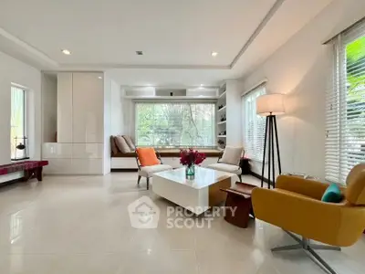 Spacious modern living room with large windows and stylish furniture