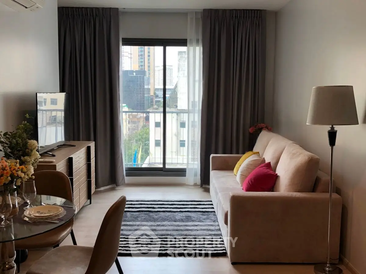 Modern living room with city view, cozy sofa, and stylish decor