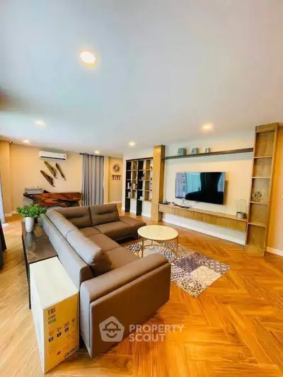 Spacious modern living room with stylish furniture and entertainment center