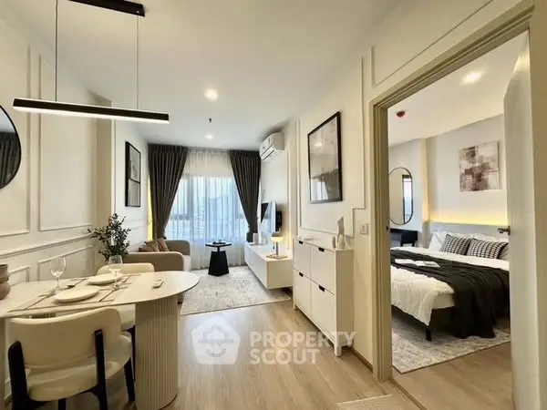 Modern open-layout living room and bedroom with stylish decor and natural light.