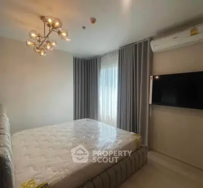 Modern bedroom with stylish lighting and wall-mounted TV