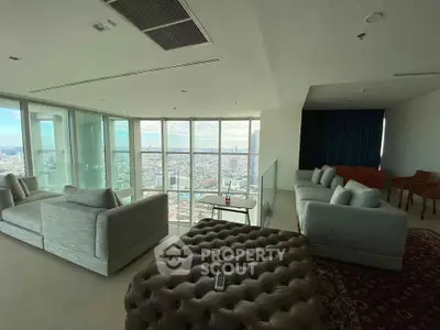 Luxurious high-rise living room with panoramic city views and elegant furnishings.