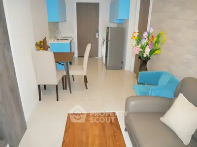 Modern open-plan living room with stylish furniture and vibrant decor in a cozy apartment.