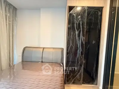 Modern bedroom with sleek design and built-in wardrobe, perfect for urban living.
