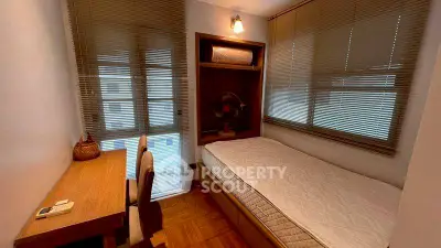Cozy bedroom with natural light and wooden flooring