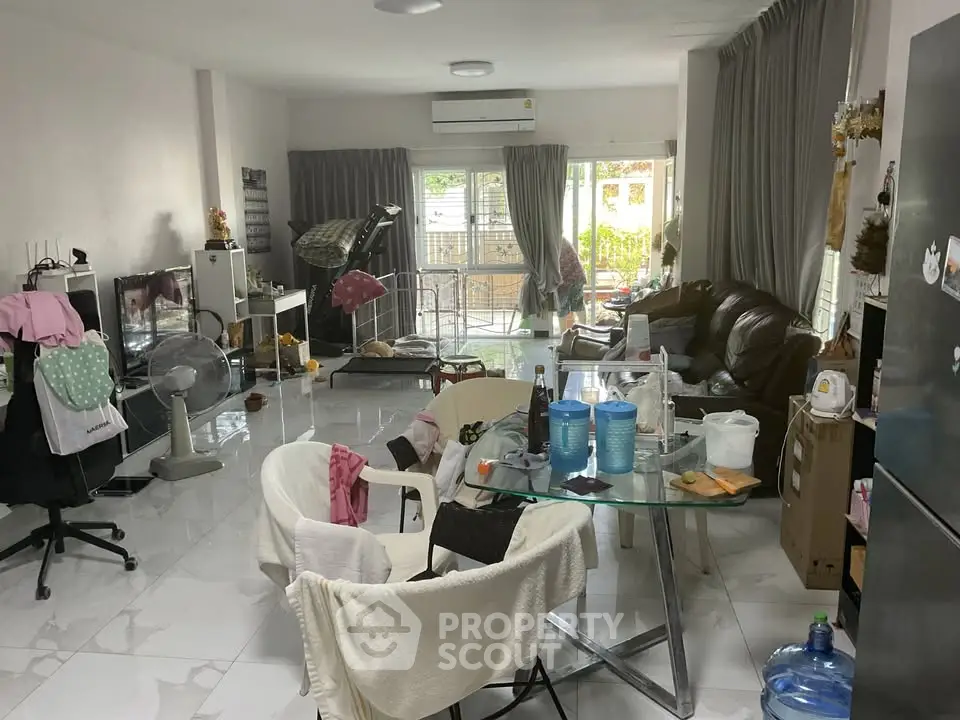 Spacious living room with modern furniture and large windows for natural light.