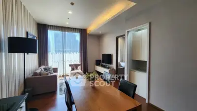 Modern living room with dining area and city view, featuring elegant decor and natural light.