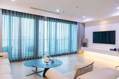 Spacious modern living room with large windows and elegant decor