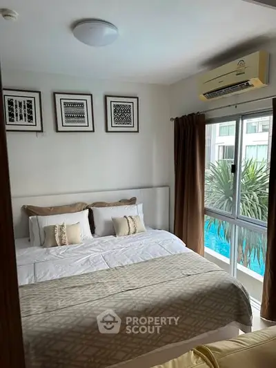 Cozy bedroom with pool view, featuring elegant decor and natural light.