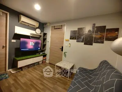 Cozy living room with modern decor, wall-mounted TV, and stylish furniture.