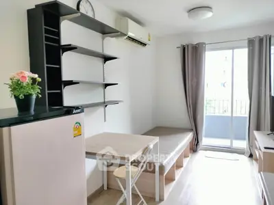 Modern living room with minimalist furniture and balcony access in a bright apartment.