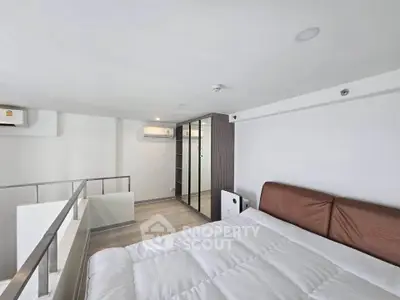 Modern loft bedroom with sleek design and ample natural light