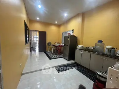 Spacious kitchen with modern appliances and ample storage in a cozy home setting.