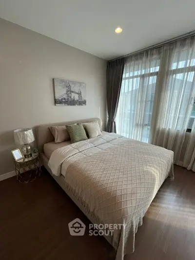 Cozy bedroom with elegant decor and large window for natural light