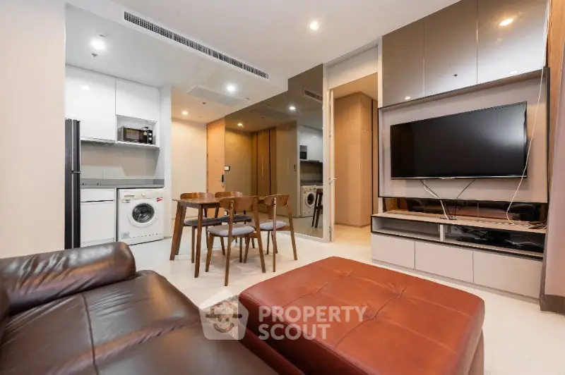 Modern living room with sleek furniture and integrated kitchen appliances