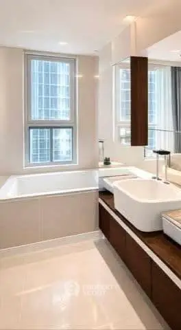 Luxurious modern bathroom with large window and elegant fixtures in high-rise apartment.